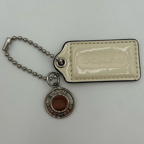 Coach Accessories - Coach Cream and Silver Disc Purse Charm Tag